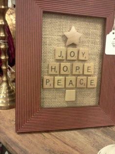 a wooden frame with scrabble letters that spell out the word joy, hope and peace