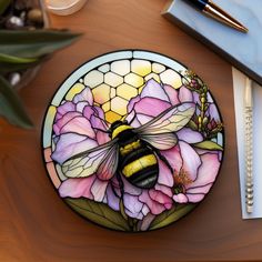 a stained glass plate with a bee on it