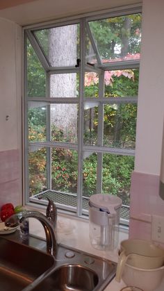 a kitchen sink with a window in the background