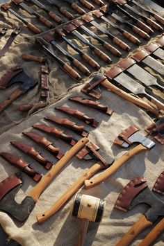 many different types of tools are laid out on a table with brown linen and tan cloth