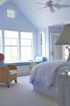 a bedroom with blue walls and white furniture