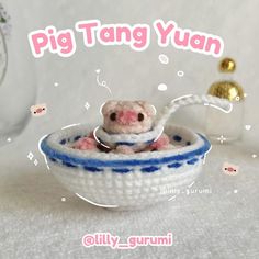 a small toy hamster in a blue and white knitted bowl, with the caption pig tang yuan