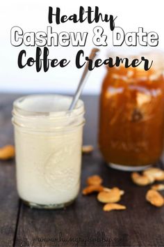 two jars filled with cashew and date coffee creamer on top of a wooden table