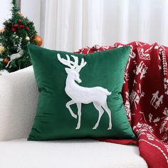 a christmas pillow sitting on top of a couch