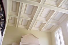 a bed sitting in the middle of a bedroom under a ceiling made of wooden paneling