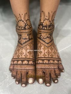 the feet are decorated with henna and elephants