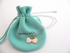 Show off your Tiffany style without ever saying a word! Here's a Tiffany & Co. Sterling Silver & 18K Rose Gold "Return to Tiffany" Mini Double Hearts necklace that is just perfect! It is the wonderful necklace that fits a lifestyle on the go -- the necklace can be worn to pretty much any occasion! It is simple, elegant, and classic all rolled into one necklace. Imagine wearing the necklace with your office attire... now imagine it with jeans or weekend wear ... Perfect anytime! The item Elegant Jewelry Charms, Elegant Heart Pendant Necklace With Hallmarks, Rose Gold Charms Necklace For Anniversary Gift, Rose Gold Charm Necklaces For Anniversary Gift, Rose Gold Necklaces With Charms For Anniversary, Luxury White Gold Necklace For Anniversary Gift, Valentine's Day Anniversary Gift Hallmarked Necklace, Luxury Heart-shaped Charms Necklace, Luxury Engraved Heart Cut Necklace