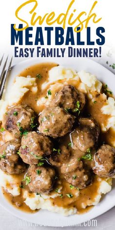 swedish meatballs with gravy and mashed potatoes on a white plate next to a fork