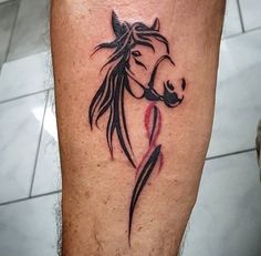 a tattoo on the leg of a man with a horse's head and tail