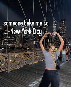 a woman standing on top of a bridge with her hands in the air and text that reads someone take me to new york city