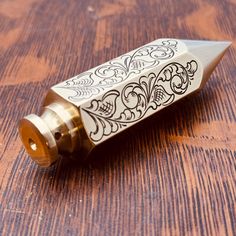 a small metal tube sitting on top of a wooden table