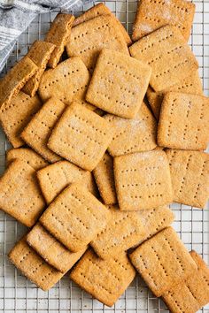 a pile of crackers sitting on top of a cooling rack next to a towel