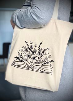 Book And Flower Tote Bag, Book Lover Gift Book Bag Painting Ideas, Painting A Canvas Bag, Book Tote Bag Painting Ideas, Tote Bag Book Design, Tote Design Ideas, Tote Bags Design Ideas, Canvas Tote Bag Painting, Bag Print Design, Tote Bag Embroidery Ideas