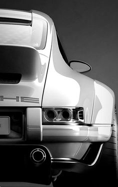 the back end of a sports car in black and white