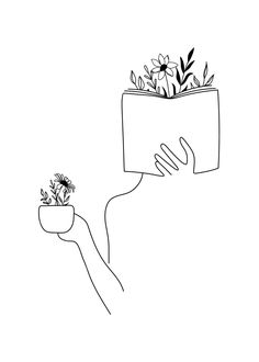 a hand holding a planter with flowers in it