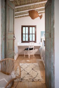 an open door leading to a bedroom with white walls and wood floors