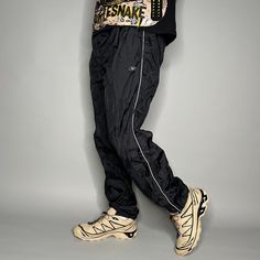 "Vintage Reebok Track Pants Jet Black Nylon Joggers White Logo Elastic Cuffs has Ankle Zippers 90s Skate / Streetwear Great Condition: 9/10 Men's Size: Large My Hands in Pockets = It has Pockets No Hands in Pockets = Does Not Have Pockets Drawstring Will be Visible in Forward Pic, if not Visible it Does Not Have a Drawstring About me: I am 6' 0\" for reference I generally wear a Large (32\" inseam) I Model XS to 2XL sweatpants, I find that you can often size up or down with 95% of sweatpants and they fit the same" Urban Style Nylon Parachute Pants For Sports, Urban Nylon Parachute Pants For Sports, Sportswear Parachute Pants For Streetwear, Casual Nylon Parachute Pants For Streetwear, 90s Style Black Sports Pants, Casual Nylon Joggers For Streetwear, Nylon Joggers For Streetwear Style, 90s Style Nylon Sports Pants, Sporty Nylon Pants For Streetwear