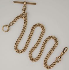 This is a long solid gold pocket watch chain. Every link is stamped 375 and 9 - for 9K gold and has hallmarks for Chester 1918 The chain is rose gold The chain measures 430mm long x 6mm wide and is long enough to be worn as a necklace and is a particular good example as it is heavier and thicker than most.  The chain weighs 57g The gold chain is made up of a single length of parallel curb links with a dog clip at one end, a bolt ring at the other and a T bar attached to a larger bolt, which allo Gold Pocket Watch Chain, Gold Pocket Watch, Bolt Ring, Vintage Pocket Watch, Dog Clip, Pocket Watch Chain, Watch Chain, Double Chain, Wedding Jewellery Necklace