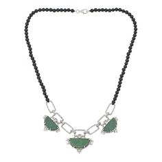 Jade of Yesteryear Gemstone Bead and Link Statement Necklace Make heads turn with this striking statement necklace featuring heirloom-look green jade. Crafted from black agate beads and sparkling white topaz-accented links, its bold yet elegant design instantly elevates any ensemble.       Approx. 18"L x 3/16"W; drop approx. 1-1/16"L     Stamped .925 sterling silver; rhodium plating     Nylon cord with lobster-claw clasp   Stone Information       All sizes and weights approximate     Green Jade Elegant Black Jade Jewelry, Elegant Jade Necklace With Stones, Elegant Emerald Necklace With Beaded Chain, Elegant Silver Jade Beaded Necklace, Elegant Onyx Necklace With Stones, Elegant Onyx Stone Necklace, Color Bands, Black Agate, Jade Jewelry