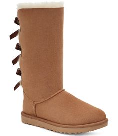 From UGG®&#x2C; the Bailey Bow II Suede Tall Water-Resistant Boots feature:Twinface and suede upperPretreated to repel water and stainsFixed bows along back shaftSheepskin insoleTreadlite by UGG™ outsolepolyester bindingApprox. 12.25" shaft heightThis product contains real fur from sheep or lamb. Fur may be sourced from Australia&#x2C; Ireland&#x2C; the United Kingdom&#x2C; or the United States. It has been artificially dyed and tr Bailey Bow Uggs Outfit, Cute Winter Boots, Ugg Bailey Bow, Bailey Bow Uggs, Ugg Bailey, Bailey Bow, Uggs Outfit, Aesthetic Shoes, All About Shoes