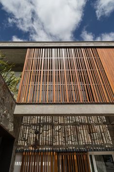 the side of a building with wooden slats on it's sides and windows