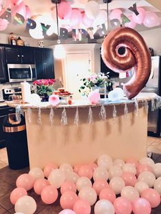 balloons and streamers are scattered around the kitchen island