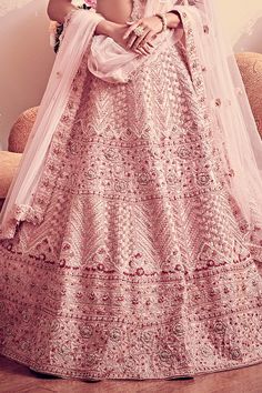 Blush pink lehenga with intricate floral and geometric motif embroidery and French knot highlights. Paired with off- shoulder blouse with tassels and embroidery work and sheer dupatta.
Component: 3
Pattern: Embroidered
Type Of Work: French Knots
Neckline: V-neck
Sleeve Type: Cap
Fabric: Lehenga and Blouse: Raw silk; Dupatta: Net
Color: Pink
Other Details: 
Floral motif embroidery
Scalloped hem dupatta
Tassel detailed blouse
Occasion: Bride, Wedding - Aza Fashions Anarkali Pink Embroidered Choli, Pink Salwar Kameez With Sheer Dupatta For Wedding, Pink Wedding Salwar Kameez With Sheer Dupatta, Pink Wedding Sets With Intricate Embroidery, Pink Designer Floor-length Saree, Pink Traditional Wear With Resham Embroidery For Wedding, Pink Resham Embroidery Traditional Wear For Wedding, Pink Salwar Kameez For Wedding And Festivals, Pink Salwar Kameez For Wedding And Festival Season