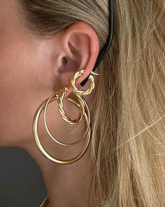 Elevate your ear game with these bold, stacked gold hoops. Perfectly layered to make a statement, these earrings bring the right touch of drama and elegance to any look. Minimal, but unforgettable.  #BoldHoops #LayeredJewelry #GoldEssentials #StatementEarrings #EffortlessGlam Gold Stackable Hoop Huggie Earrings, Gold Small Hoop Stackable Earrings, Small 14k Gold Stackable Hoop Earrings, Elegant Gold Stackable Hoop Earrings, Minimalist Yellow Gold Stackable Hoop Earrings, School Jewelry