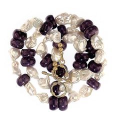 This is part of Chairish’s Fine Jewelry assortment.  24-25 Inch Expandable necklace of creamy white freshwater pearls of interesting shapes and smooth purple Charoite rondelles.  These iridescent pearls juxtapose with the purple Charoite for an elegant fresh look in a pearl necklace. Wear this necklace just because it makes you feel so good. Elegant Mother Of Pearl Necklace With Gemstone Beads, Elegant Lavender Pearl Necklace With Round Beads, Purple Single Strand Pearl Necklace, Purple Pearl Single Strand Jewelry, Purple Pearl Jewelry With Natural Stones, Purple Pearl Drop Jewelry, Purple Single Strand Pearl Jewelry, Elegant Purple Pearl Bracelet With Round Beads, Purple Pearl Jewelry For Formal Occasions