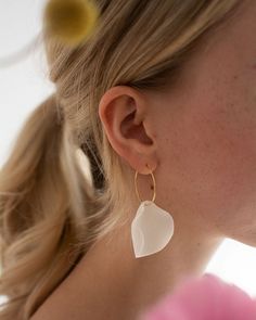 White porcelain earrings in the shape of flower petals. Minimalistic and perfect to wear - porcelain earrings are very lightweight! You will barely notice that you have them in your ears. Perfect for everyday wear and going out, purchased frequently by brides. Handmade in a small ceramic studio in Warsaw, Poland. Each piece is unique and may vary slightly. Rings made of antiallergic gold plated stainless steel. SIZE AND MATERIAL Measures: width 3.1 cm, lenght (with a ring) about 5.6 cm Weight: about 3 g Materials: pigmented porcelain, gold plated stainelss steel rings, antiallergic. OTHER AVAILABLE COLOURS Baby blue:  Pink: OTHER ITEMS FROM THIS COLLECTION In my shop you will find a collection of porcelain flower petal jewelry, it consist also of pendants and bigger earrings in different c Flower Petal Jewelry, Minimalist Jewellery, Porcelain Earrings, Earrings Big, Jewelry Minimalist, Warsaw Poland, Jewellery Gold, Porcelain Flowers, Flower Petal