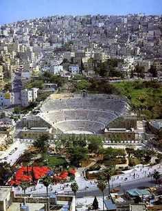 an aerial view of a stadium in the middle of a city with lots of tall buildings