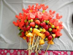 there are many fruits arranged on sticks in the shape of bear's heads and bears