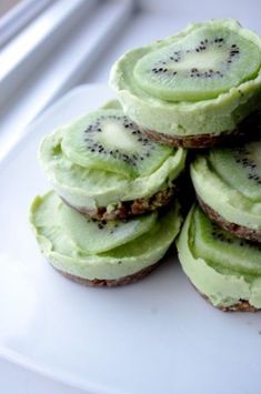 a white plate topped with cookies covered in kiwi