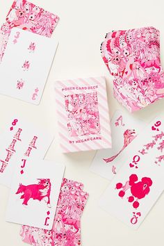 pink and white paper cut out into heart shapes on top of each other next to some cards