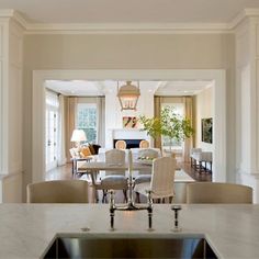 a kitchen and dining room with marble counter tops