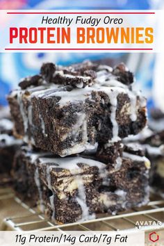 healthy fudge oreo protein brownies stacked on top of each other with icing