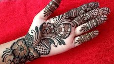 a woman's hand is decorated with hennap and intricate designs on it