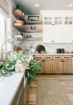 a kitchen with wooden cabinets and white marble counter tops