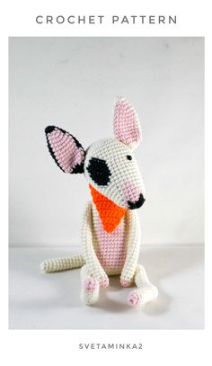 a crocheted rat sitting on top of a white surface