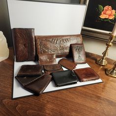 Vintage leather accessories, wallet, clutch, billfolds, luggage tag Approximate dimensions: A: 10" open B: 9" open C: 8.5" open D: 9" open, black leather, snap closure works, contents included (pictured) E: 3.5" wide, snap closure works but tarnished F: 3.5" wide, snap closure works but tarnished G: 9.5" open H: 3.5" long I: 10" open, contents included (pictured) J: 7" x 4" contents included (pictured), snap closure works but tarnished K: 11.5" x 5.5", snap closures work Used condition see pictures Vintage Brown Card Holder For Travel, Vintage Leather Trifold Wallet For Travel, Vintage Brown Wallet For Travel, Vintage Brown Bifold Bag, Vintage Brown Travel Wallet, Vintage Hand-tooled Trifold Wallet, Brown Hand Tooled Trifold Wallet, Vintage Hand-tooled Wallets As Gift, Brown Hand Tooled Trifold Wallet As Gift