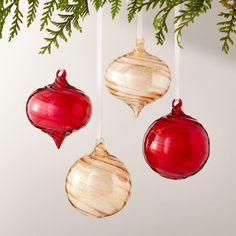 three ornaments hanging from a christmas tree