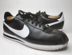 Elevate your sneaker game with these Nike Classic Cortez '72 black leather athletic sneakers. Featuring a lace-up closure, these shoes are perfect for any occasion, from casual wear to activewear. These sneakers were manufactured in 2016 and released in 2017, and are a perfect blend of classic and sports themes. The rubber outsole provides comfort, making them ideal for walking, school, basketball, or running and jogging. The leather upper material and fabric lining ensure a standard shoe width, making them suitable for any foot size. The Cortez character is a perfect representation of timeless style, and these shoes are no exception. Add these Nike Classic Cortez sneakers to your shoe collection for a touch of classic sophistication. Cortez Sneakers, Nike Classic Cortez, School Basketball, Classic Cortez, Nike Classic, Sneaker Games, Nike Cortez, Athletic Sneakers, Timeless Style