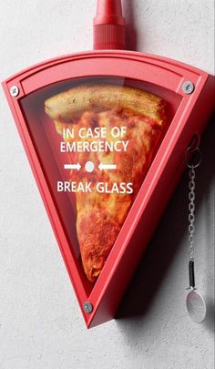 a slice of pizza hanging from the side of a wall next to a bottle opener