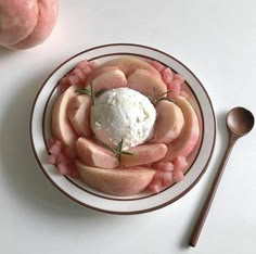 a white plate topped with sliced peaches and ice cream