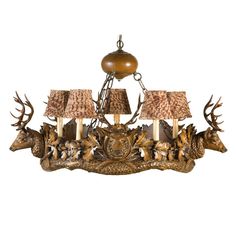 a chandelier with deer heads and lamps on it