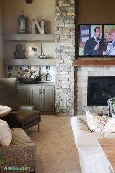 a living room filled with furniture and a flat screen tv mounted on the wall above a fireplace