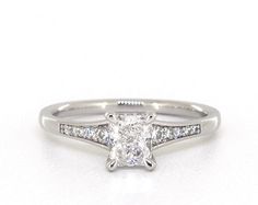 a white gold engagement ring with a princess cut diamond set in the center and side stones