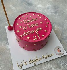 a pink birthday cake with gold hearts on it and the words bene bi tone donut 1