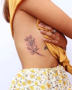 a woman with a flower tattoo on her back