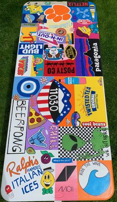 a large mat covered in lots of different types of stickers and logos on the grass